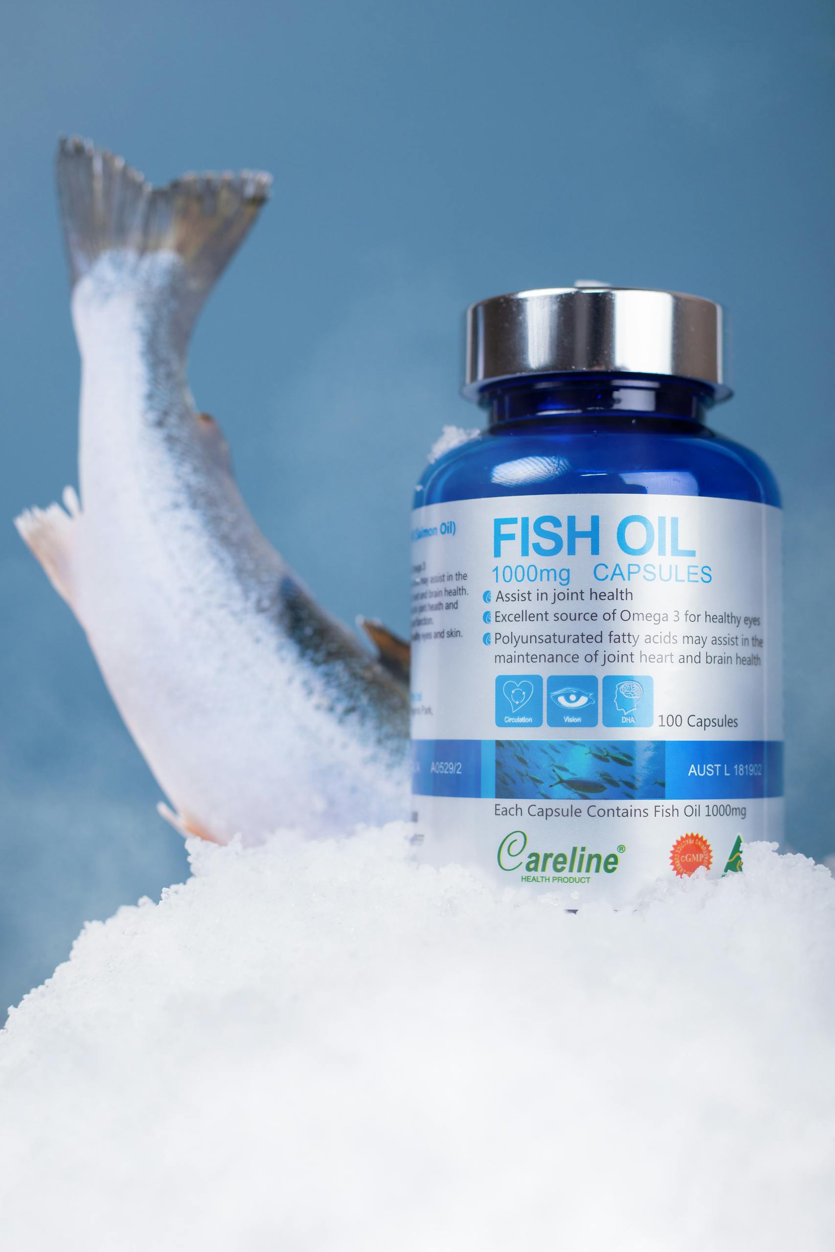 Fish oil capsules with salmon on ice, promoting joint health.